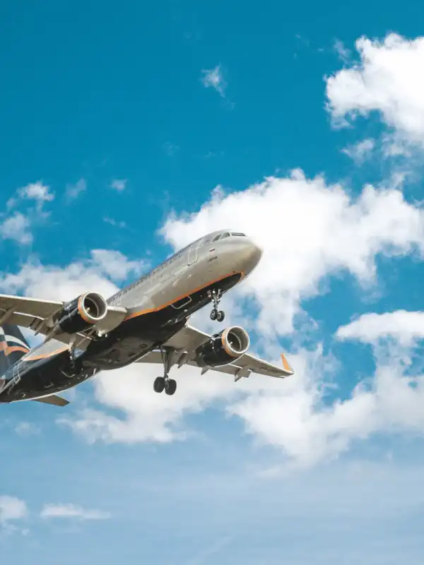 Airplane wing at sunset — global flight ticketing